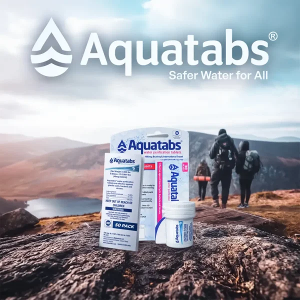 Box and bottle of Aquatabs water purification tablets on a rock, with hikers in the background.