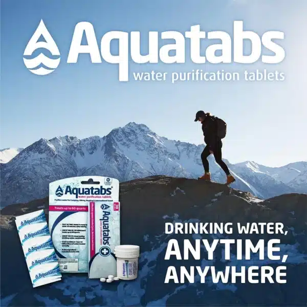 Hiker atop a rocky summit with Aquatabs water purification products in the foreground and the slogan 'Drinking Water, Anytime, Anywhere.'